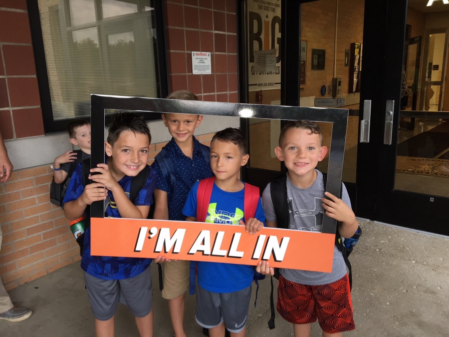 people holding a frame sign